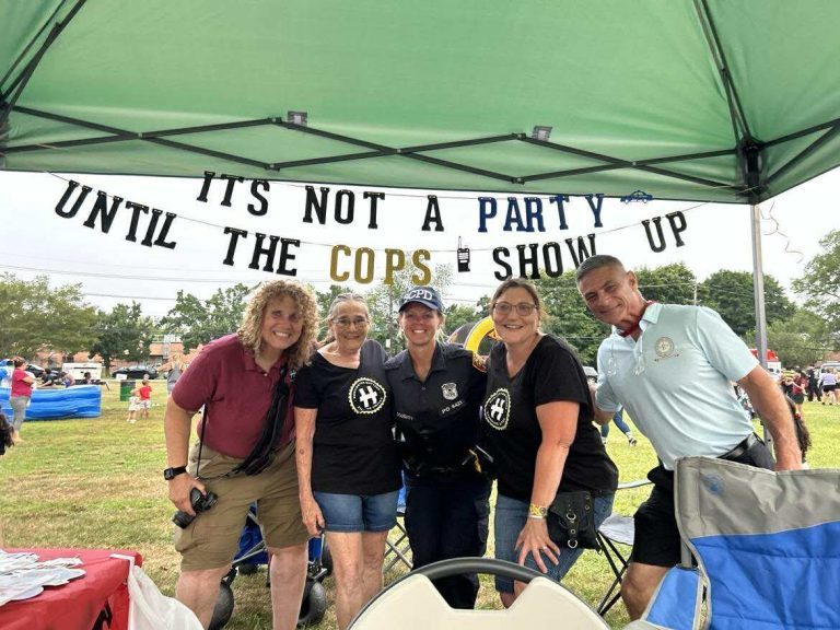 National Night Out 2025: Dana E. Richter, Diane Schaber and June Margolin of Huntington Matters with SCPD 2nd Precinct Officer Ilyssa Doughty and Town Councilman Dr. Dave Bennardo under our sign "It's not a party until the cops show up"