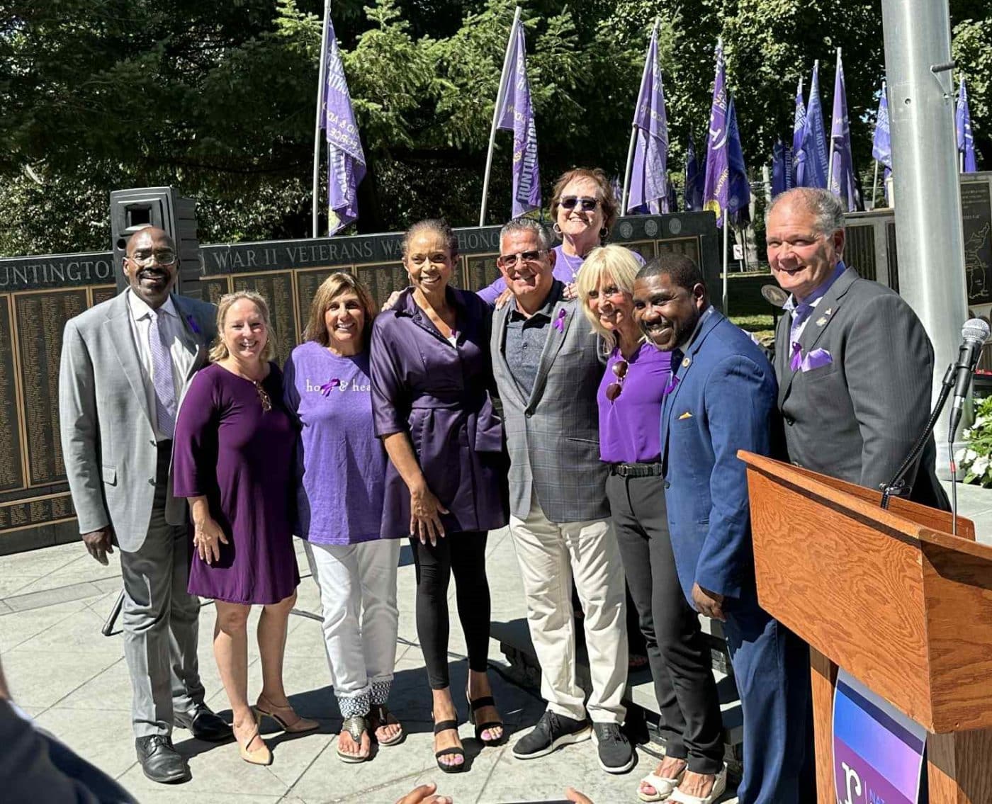 National Recovery Month Purple Flag Raising Ceremony - Suffolk County Department of Health Commissioner Dr. Gregson Pigott (1st), Suffolk County Legislators Rebecca Sanin (2nd) and Jason Richburg (8th), Huntington Opioid and Addiction Task Force Members Barbara Posillico (3rd), Mary Silberstein (6th Top) and Sharon Richmond (7th). Town of Huntington Receiver of Taxes Jillian Guthman (4th) and Councilman Salvatore Ferro (5th) with New York State Senator Mario Mattera (9th).