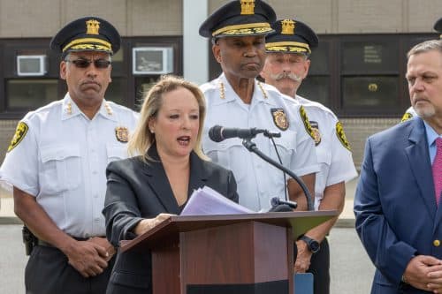 Handle with Care Pilot - Suffolk County Legislator Rebecca Sanin speaks with Suffolk County Sheriff Errol Toulon, Jr. to her right.