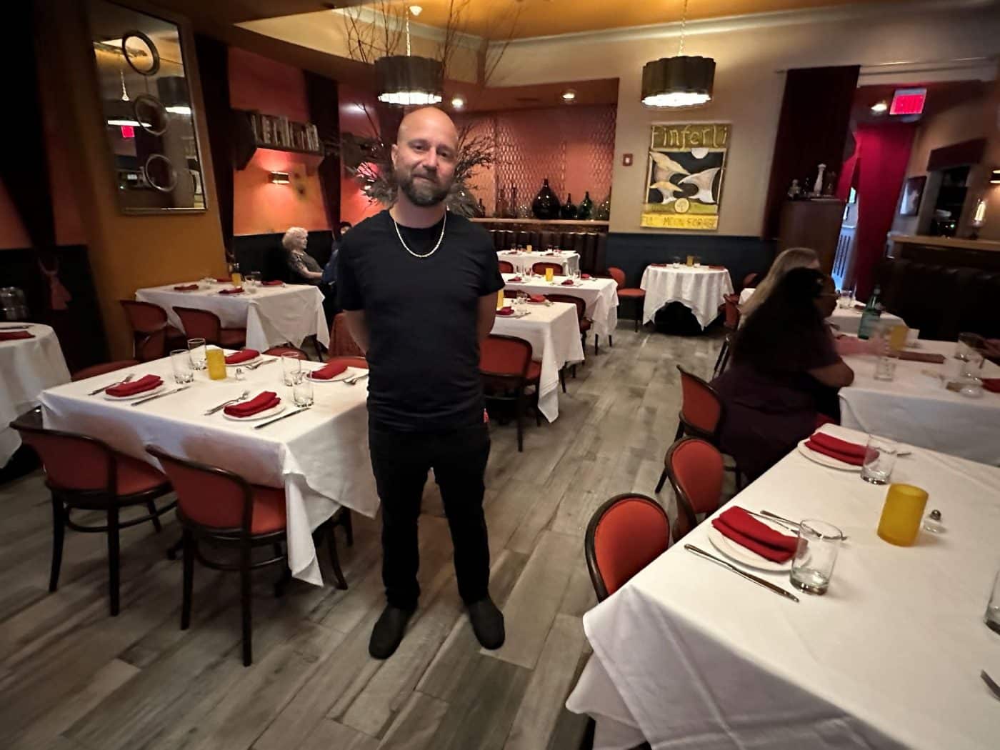 Hurry Red Restaurant Closing September 21st server Christopher in the dining room.