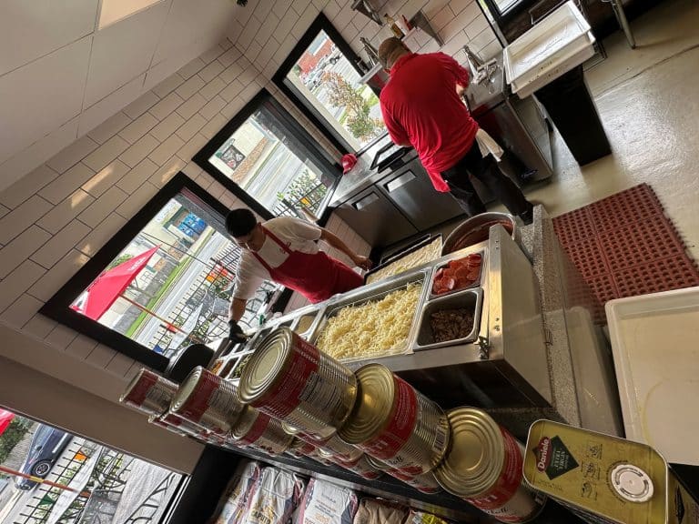 Paulie's Pizzeria Opens in Huntington Station - Pizza maker with a handful of toppings.