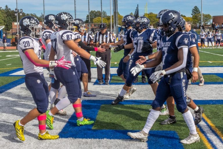 Northport High School "Navy" Tigers and Huntington High School "Army" Blue Devils shake hands. High School Army Navy Game