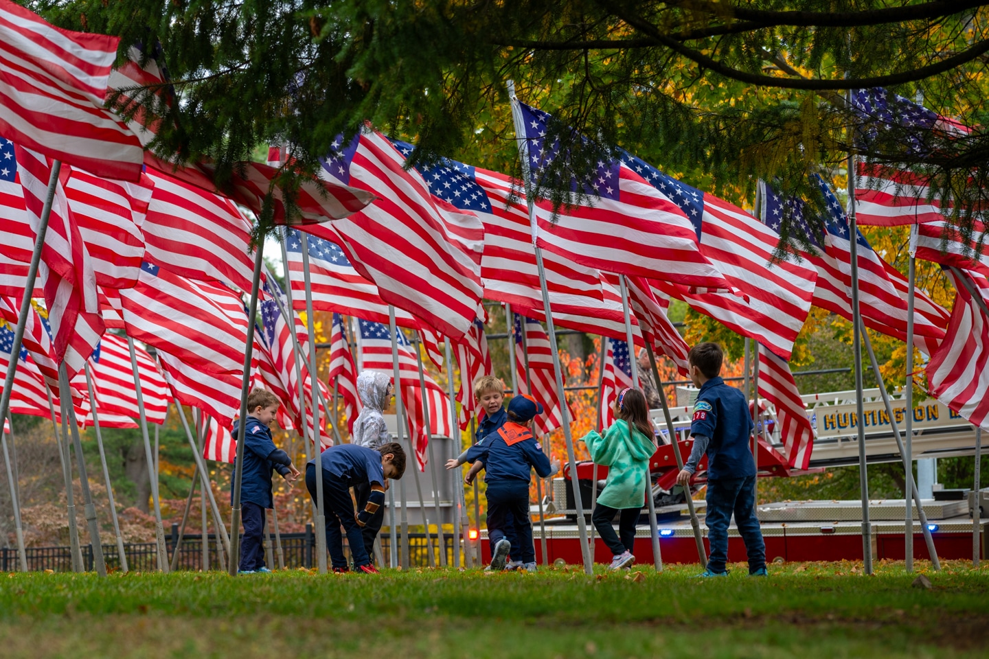 Child scouts playing among the American Flags. Huntington Veterans Wreath Laying Ceremony
