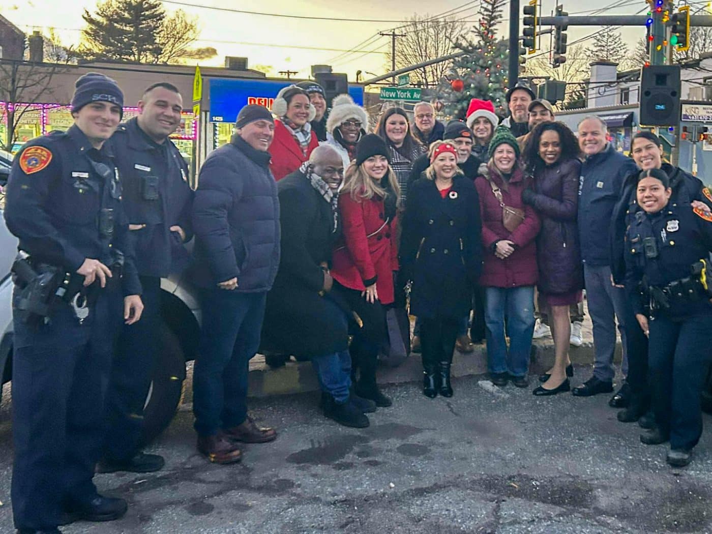 Top: Jonas Wagner - Huntington Citizens Advocate; Andrea Bonilla, Rhonda Taylor-Gooden, Kelly Smith, James Izzo, Maria Lella, Chris Melz - Huntington Station BID with unknown man. Bottom: 2 Suffolk County Police Department 2nd Precinct Officers, Deputy Inspector Steven Rohde; Ken Patrick Johnson, Andrea Pane - Huntington Station BID; County Legislator Rebecca Sanin; Frank Cosentino - Huntington Station BID; Elissa Kyle - Volunteer; Jillian Guthman - Receiver of Taxes; Ed Smyth - Supervisor; 2 Suffolk County Police Department 2nd Precinct Officers. Huntington Station Business Improvement District Tree Lighting