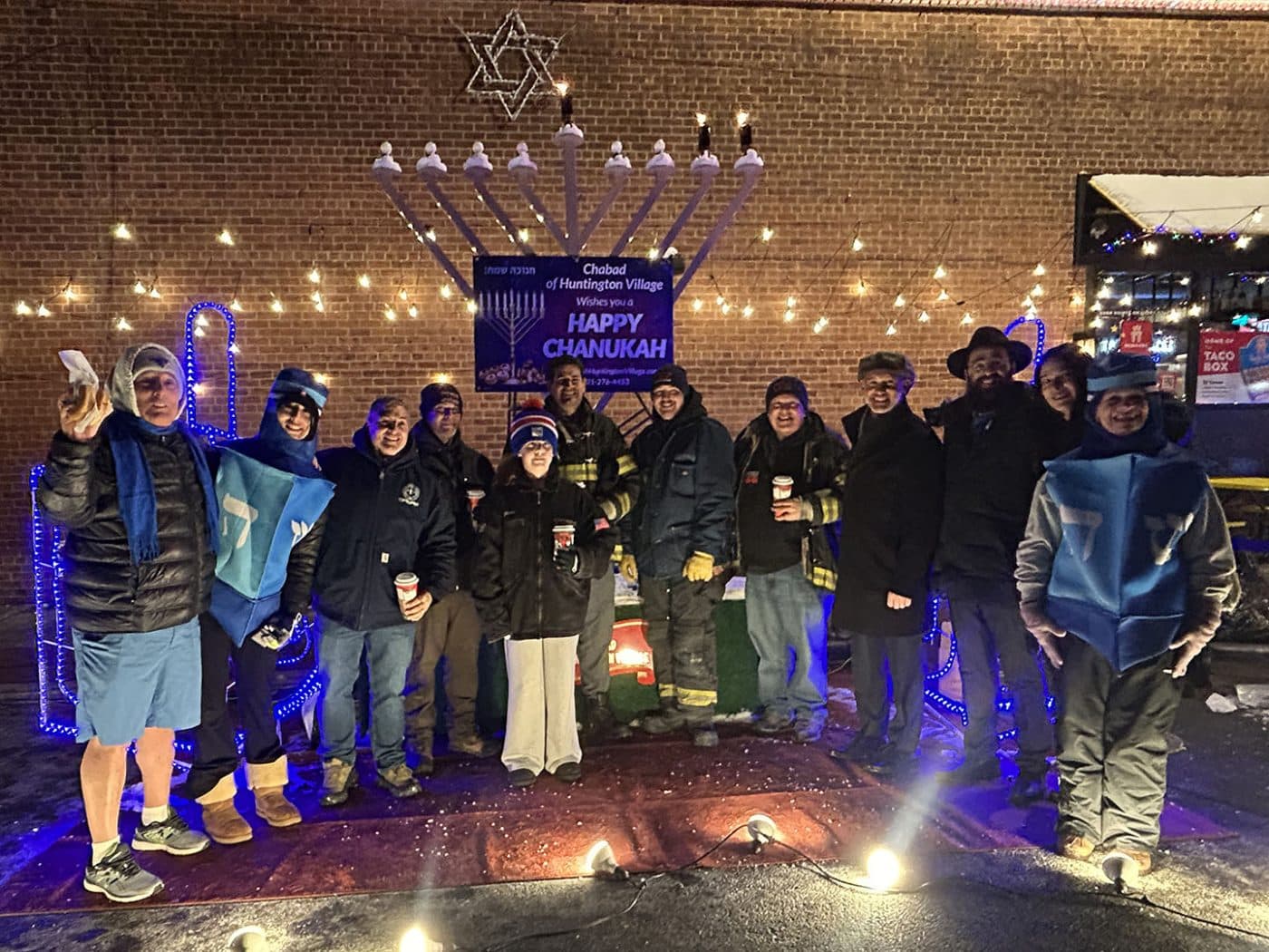 Steve Stern - NY State Assemblyman (4th from R) and Rabbi Yaakov Raskin (3rd from R) with Huntington Fire Department volunteers, Town of Huntington Staff and attendees. Huntington Menorah Lighting