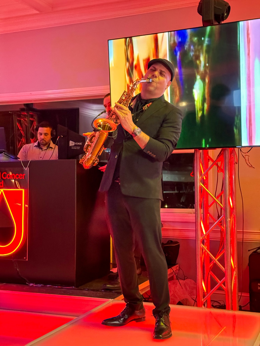 Live saxophone player accompanies the DJs music. All Stars United Student Fundraiser Photo Stories