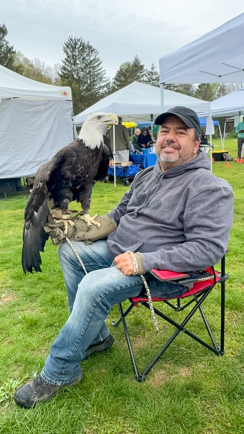 Rob Schwartz, founder of Bald Eagles of Centerport, NY holds Montana a rescued disabled Bald Eagle. Huntington Family Earth Day Highlights Environmental Programs and Wildlife Education