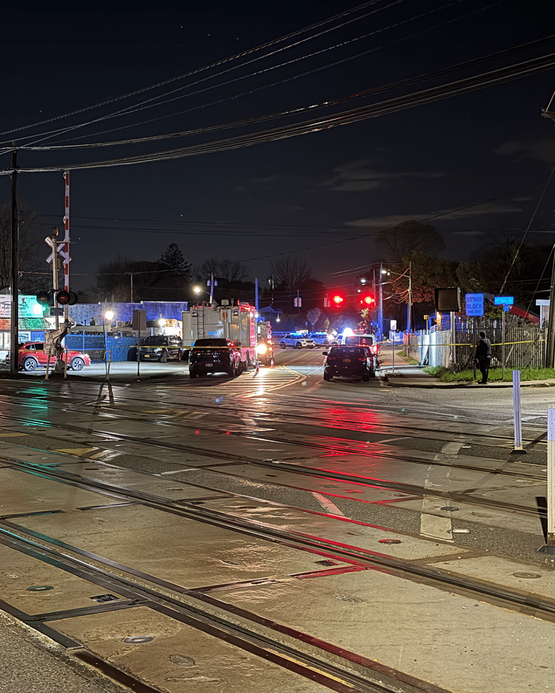 Pulaski Road looking West over the LIRR crossing with SCPD Mobile Command Post truck and other police vehicles visible as the investigation continues. One Person Killed in Targeted Huntington Station Shooting