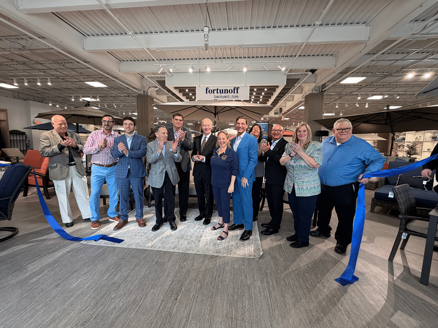 CEO Curt Littlejohn (center) with Suffolk County Legislator Rebecca Sanin together with corporate officials, and store staff. Fortunoff Backyard Store Opens in Huntington Station, Taking Over Former Sam Ash