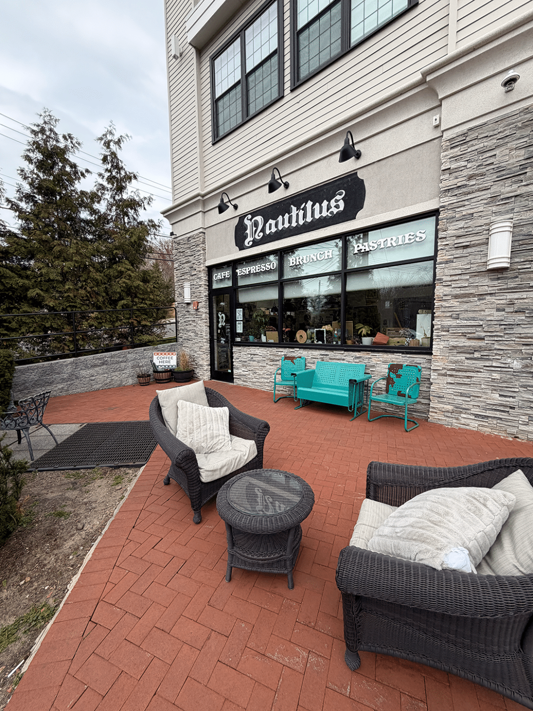 Nautilus exterior with brick patio seating area. Nautilus Roasting Co: One of Huntington Station’s Most Unexpected Spaces