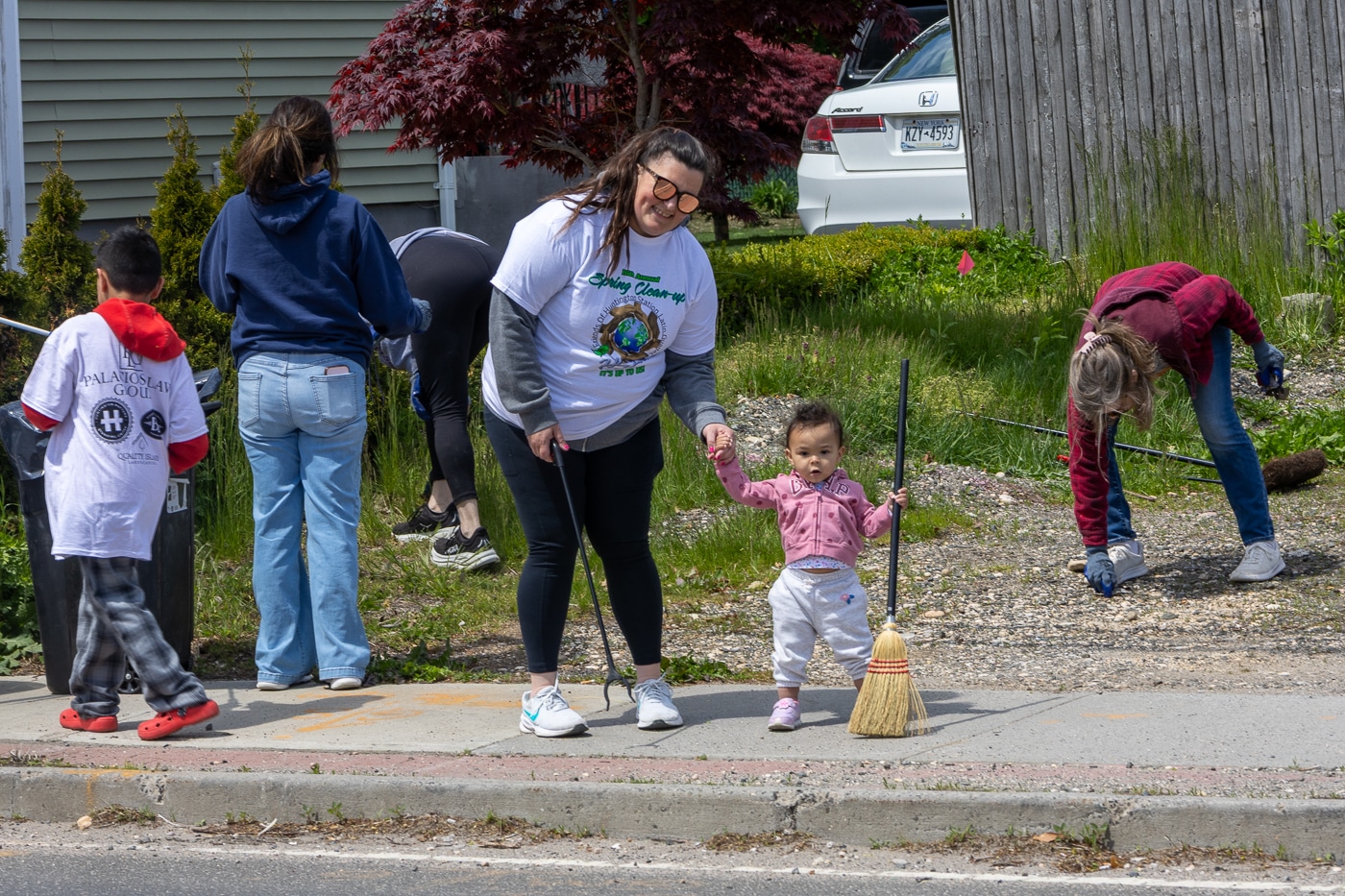 Kelly Smith and daughter Marina sweeping - Huntington Station BID, Huntington Chamber & Huntington Rotary Club. Huntington Station Latin Quarter and Huntington Matters Host 16th Annual Spring Cleanup