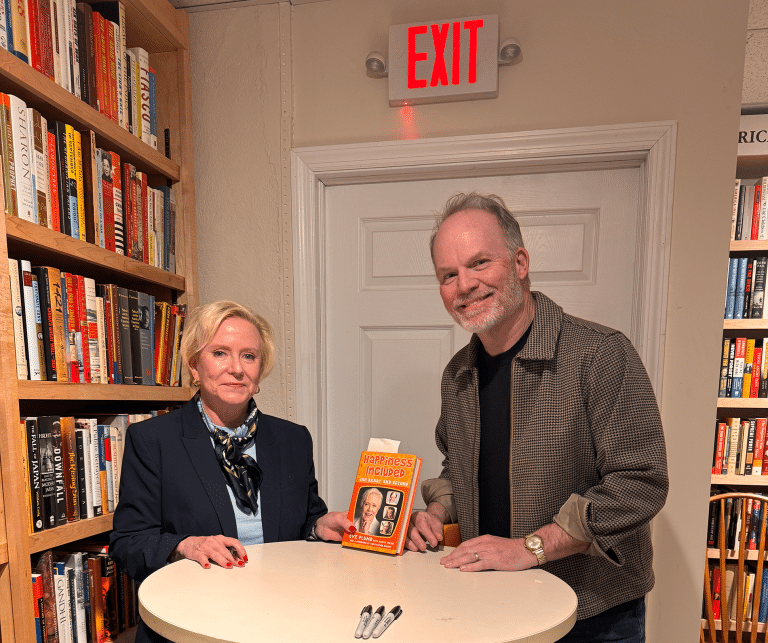 Actor Eve Plumb holding her book with fan Scott Matheny. Brady Bunch Star Eve Plumb Connects with Fans at The Next Chapter