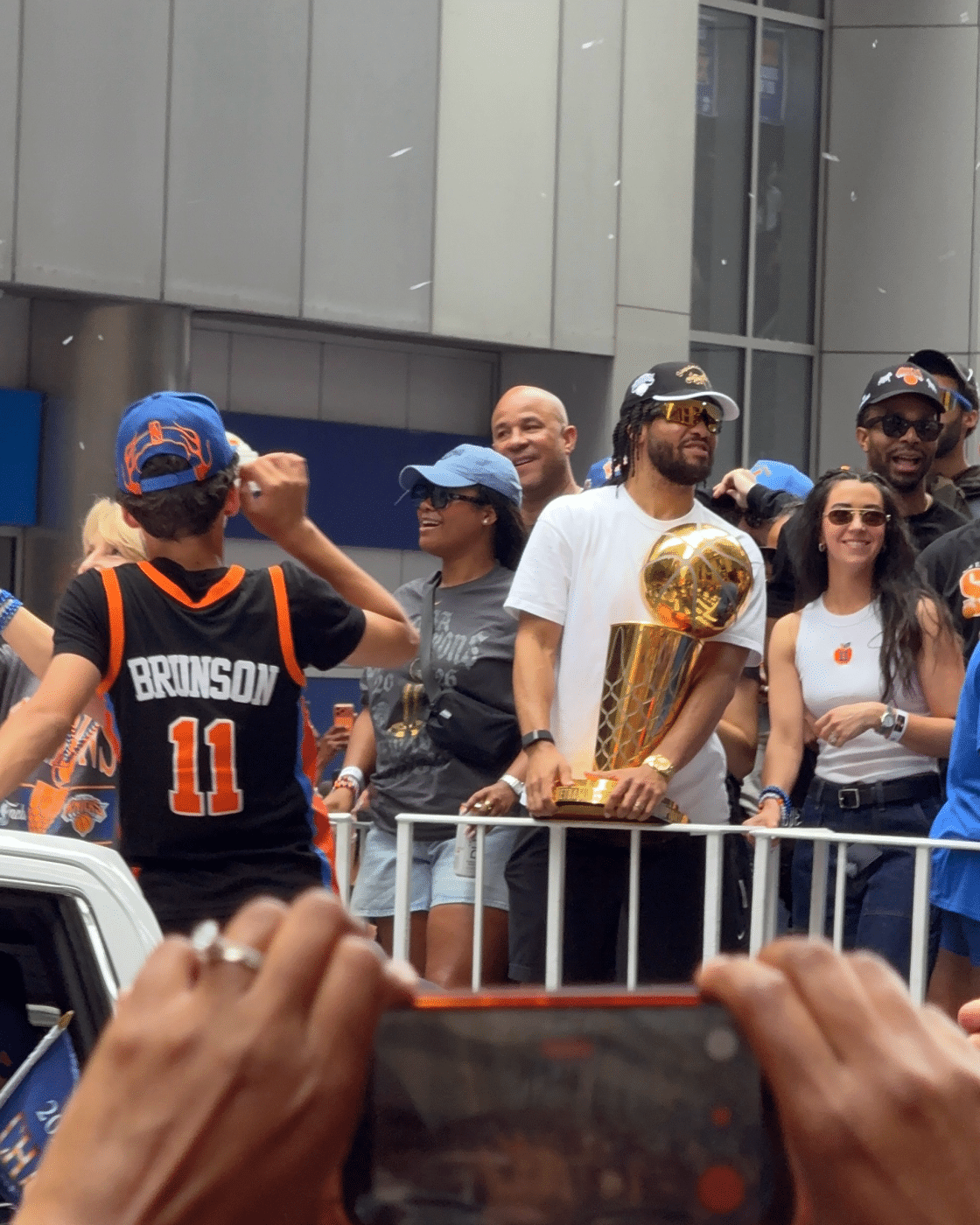 New York Knicks Finals MVP Jalen Brunson holds the Larry O'Brien Championship Trophy. Crowds, Chaos, and Knicks Pride: One Fan’s Parade Experience