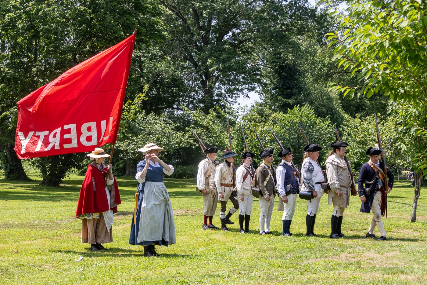 Colonist Heidi Jordan plays "Yankee Doodle" on the flute alongside the marching Militia. Huntington Recreates July 22, 1776 During America's 250th Celebration