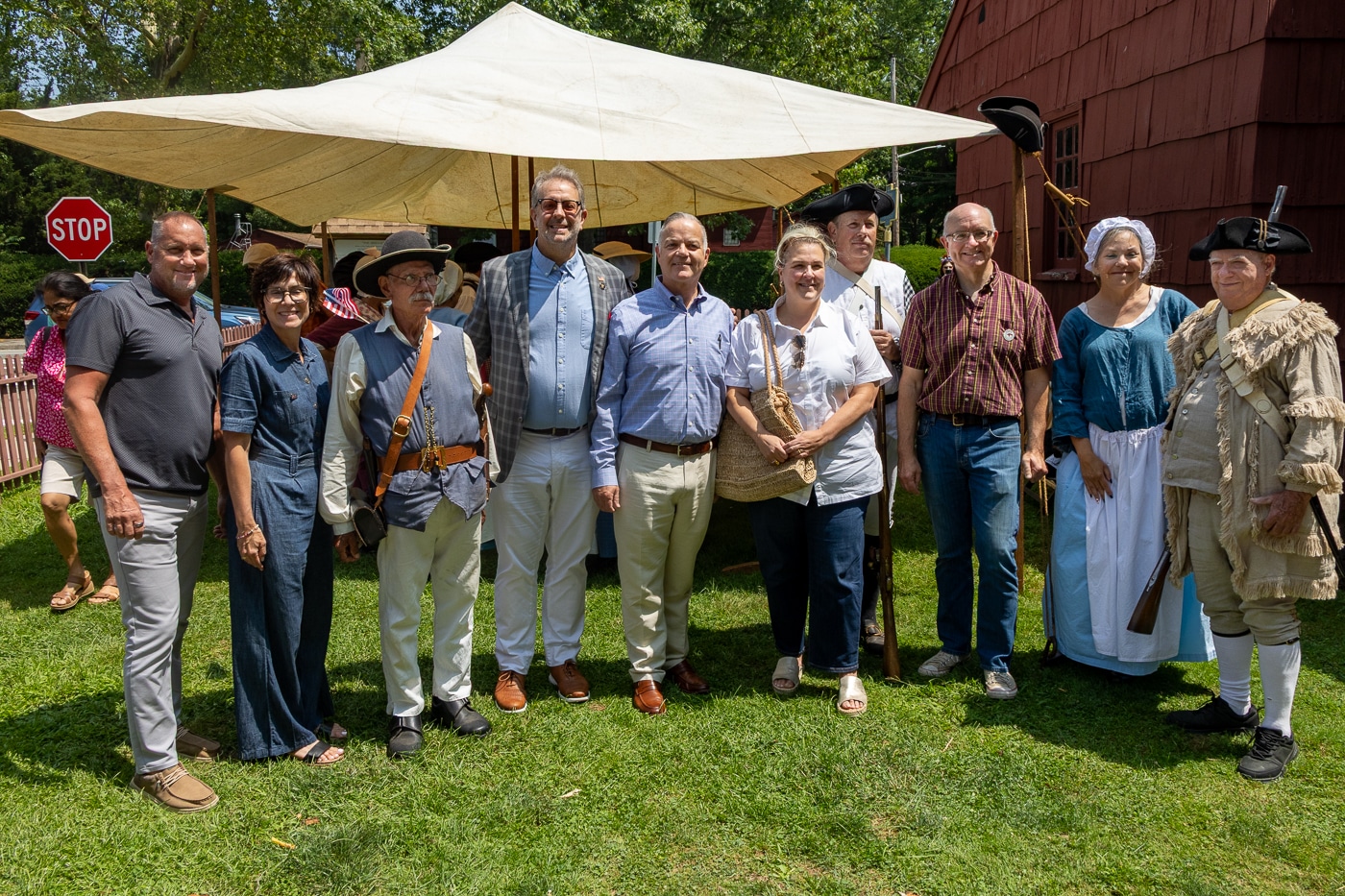 John McCarron - Deputy Supervisor, Town of Huntington; Stephanie Gotard - Executive Director, Huntington Historical Society; Vinnie Denardo - Volunteer, Huntington Militia; Keith Brown - New York State Assemblyman; Ed Smyth - Supervisor, Town of Huntington; Brooke Lupinacci - Huntington Town Councilwoman; Greg Gollatz - Volunteer, Huntington Militia; Robert Hughes - Historian, Town of Huntington; Volunteer Colonist Re-enactor with Volunteer Rifleman - Huntington Militia. Huntington Recreates July 22, 1776 During America's 250th Celebration