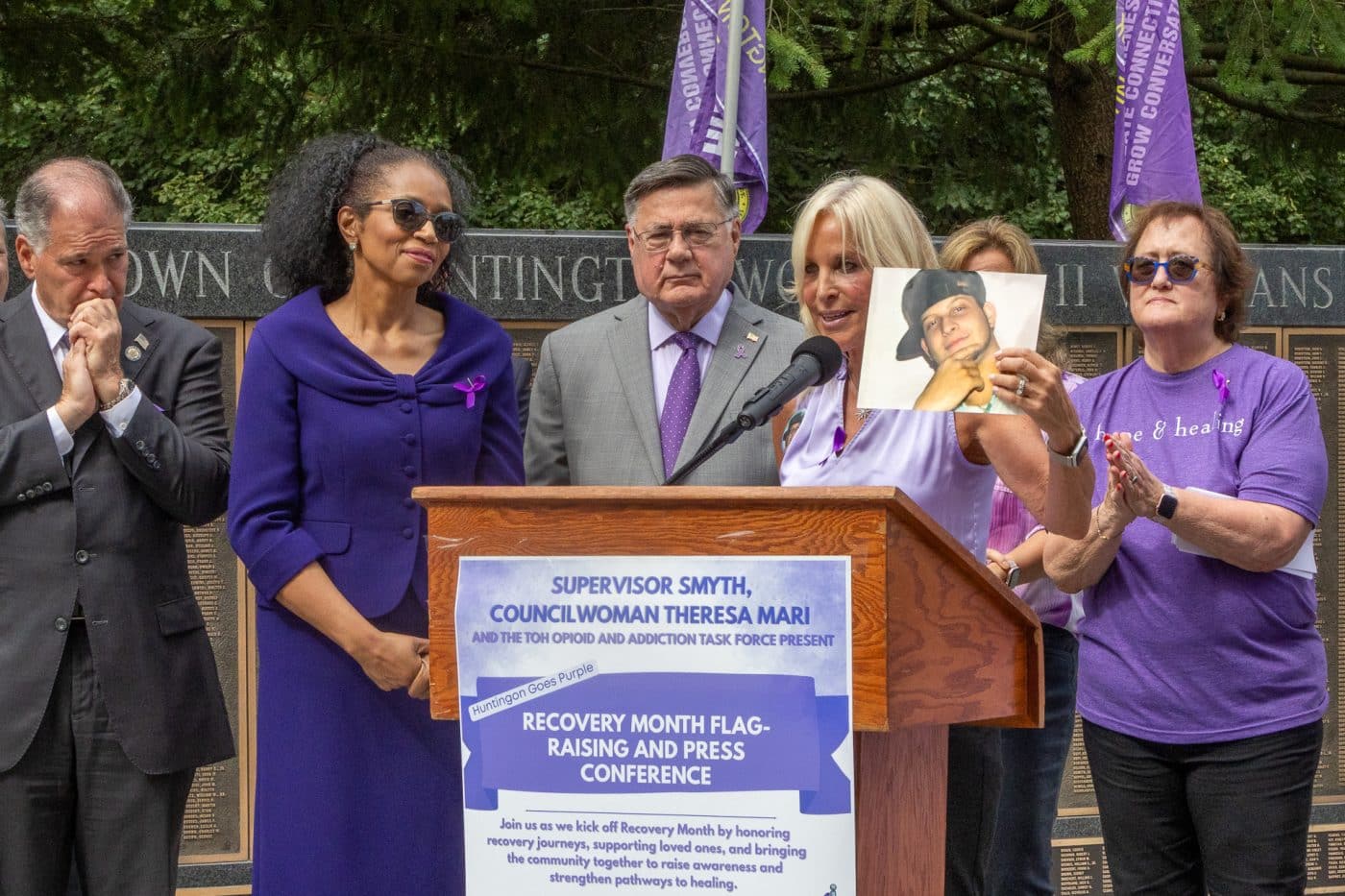 NYS Senator Mario Mattera, Huntington Receiver of Taxes Jillian Guthman, Suffolk County Executive Ed Romaine, Co-Chair Mary Silberstein (right) - Huntington Opioid and Addiction Task Force with Task Force Member and "Huntington Goes Purple" creator Sharon Richmond, holding a photo of her son Vincent - her inspiration to advocate for change and healing. Huntington ‘Goes Purple’ to Kick Off National Recovery Month, Raising Flag of Hope and Remembrance