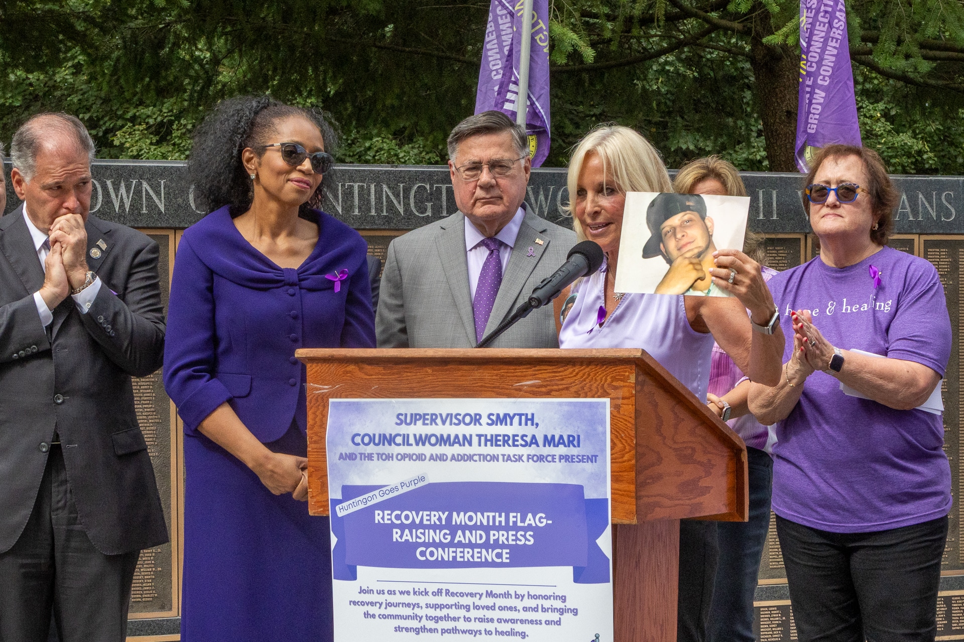 NYS Senator Mario Mattera, Huntington Receiver of Taxes Jillian Guthman, Suffolk County Executive Ed Romaine, Co-Chair Mary Silberstein (right) - Huntington Opioid and Addiction Task Force with Task Force Member and "Huntington Goes Purple" creator Sharon Richmond, holding a photo of her son Vincent - her inspiration to advocate for change and healing. Huntington ‘Goes Purple’ to Kick Off National Recovery Month, Raising Flag of Hope and Remembrance