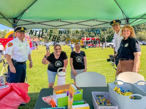 Deputy Inspector Steven Rohde and Inspector Markus Rivera visit the Huntington Matters booth with June Margolin, Diane Schaber and Dana Richter. National Night Out Brings the Huntington Community Together at Manor Field Park