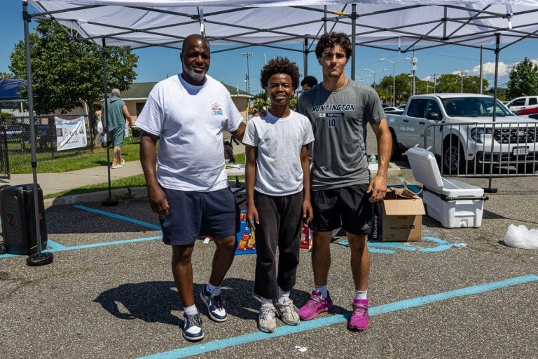 Event organizer Huntington's Director of Human Services Kevin Thorbourne (left) with Huntington High School students Ze’von McCoy, a ninth grader, and Robbie Campbell, a senior, tied in the 3 Point Shooting Contest high school division. Young Athletes Take the Court at Breezy Park Basketball Tournament