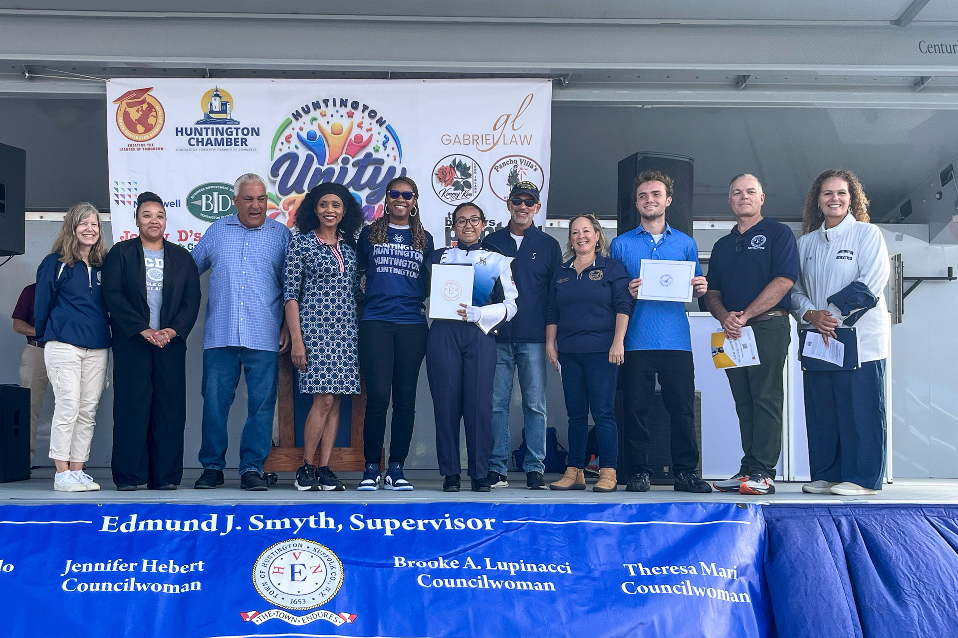 Local officials from Town County and State pose with Scholarship recipients and Honorees. Huntington Unity Fun Day Honors Local Leaders and Students