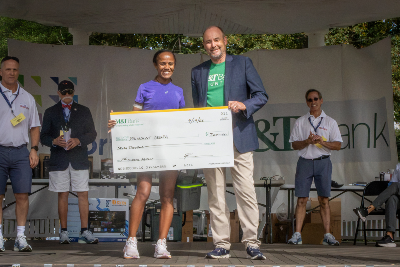 Jason Lipiec - Executive Vice President and Long Island Regional President at M&T Bank, Jason Lipiec, presenting a check for $7,000 to Biruktayit Degefa for Winning Female Open 1st-Place. The Great Cow Harbor 10K Run 2026 in Northport NY