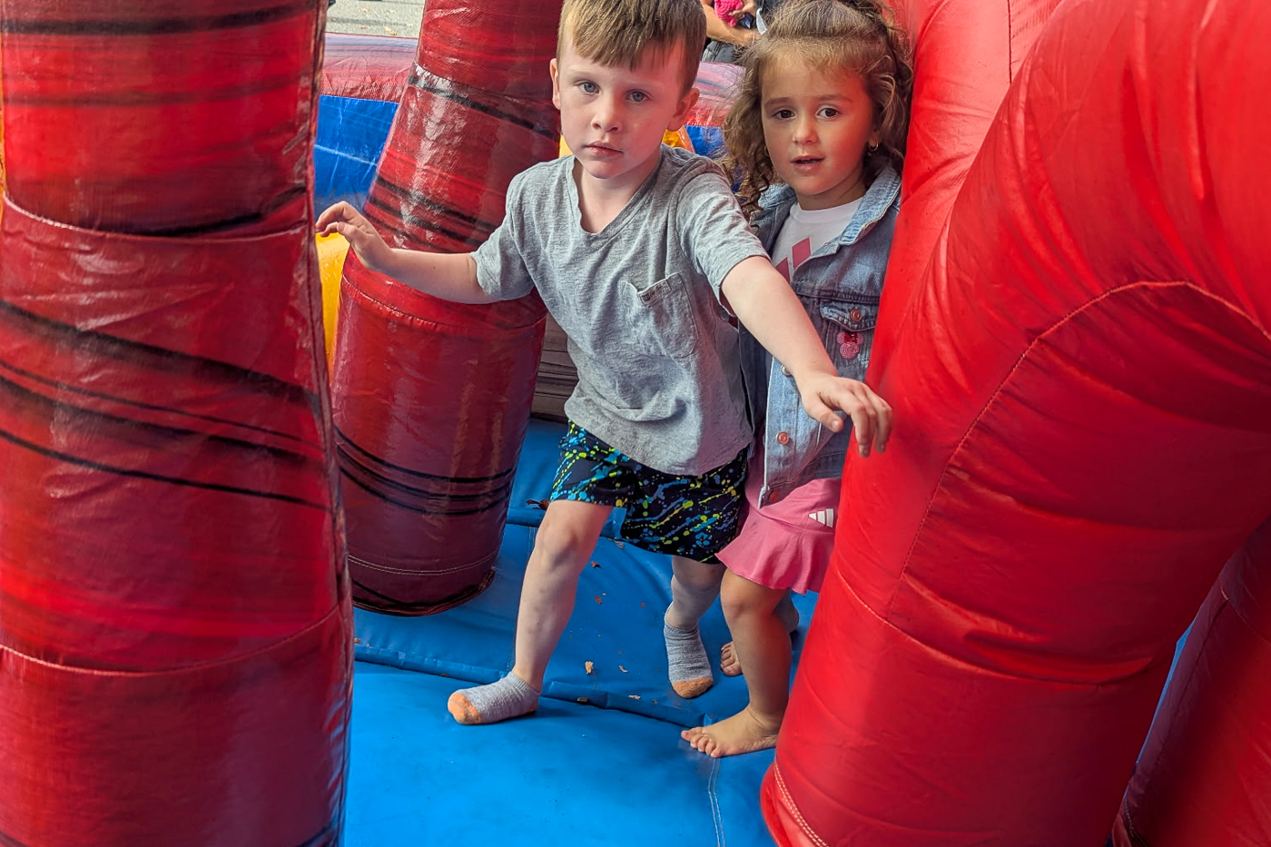 A young boy and young girl play on an inflatable ride. Huntington Unity Fun Day Honors Local Leaders and Students