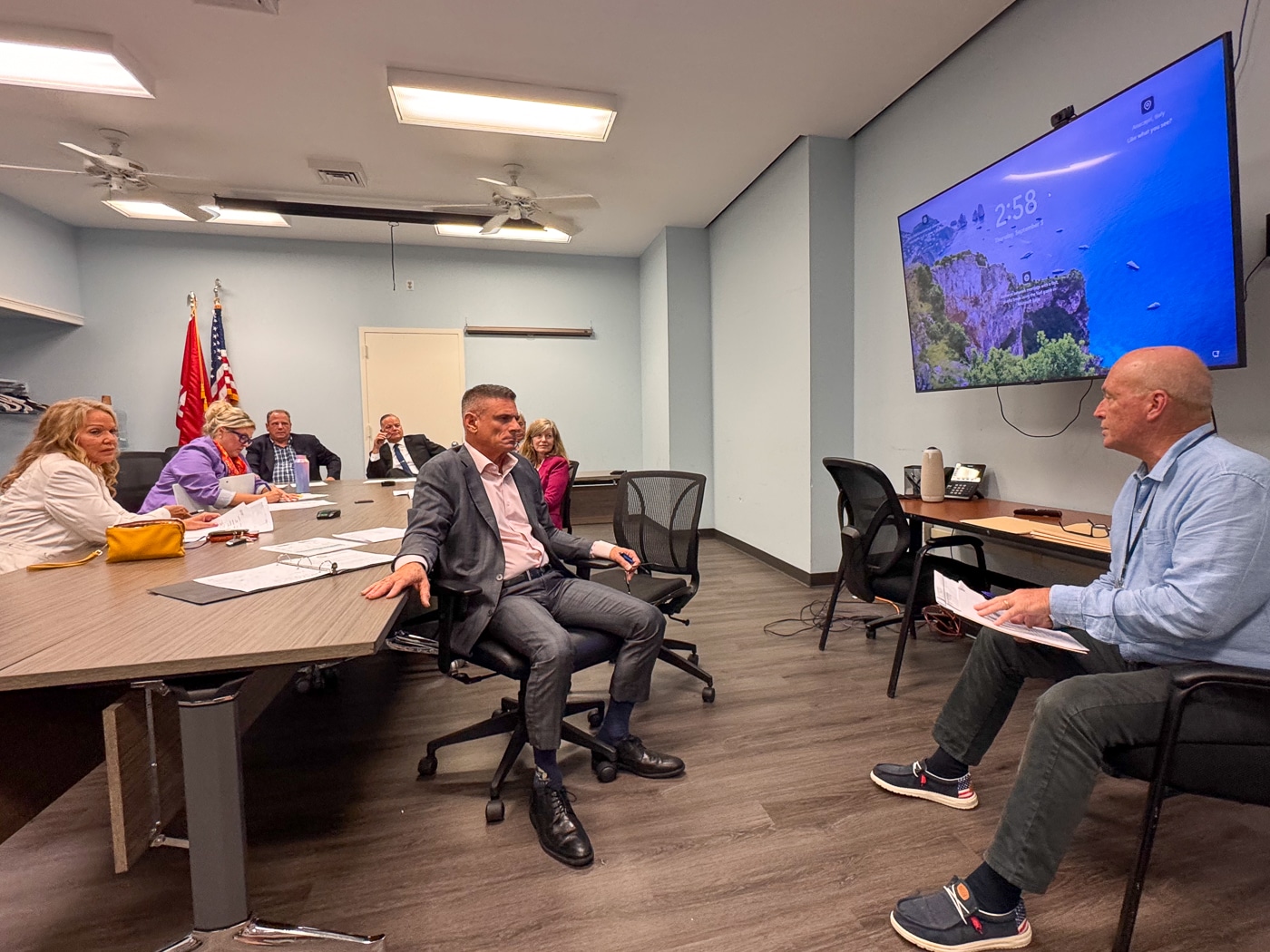 Councilwomen Theresa Mari and Brooke Lupinacci, Town Clerk Andrew Raia, Town Supervisor Ed Smyth, Councilpeople Jen Hebert and Dr. Dave Bennardo listen to Director John Clark of Environmental Waste Management. Huntington Weighs Cuts as 19% Tax Increase Enters Budget Talks
