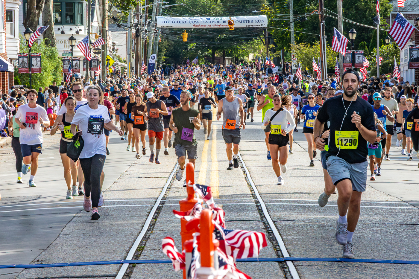 Thousands of runners of all ages approaching the Finish Line. Northport 2026 Great Cow Harbor 10K Run race