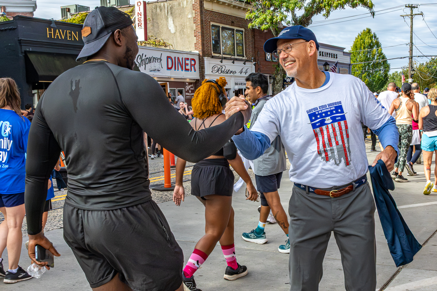Nick Fetterman, President of Huntington Hospital/Northwell Health - a Participating Sponsor of the 10K - Hands Out Towels to The Runners. 2026 Great Cow Harbor 10K Run race