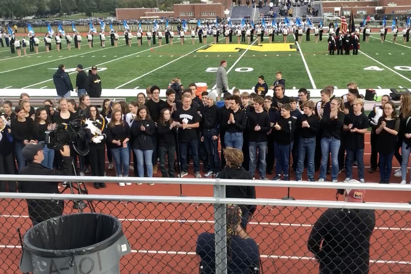 Miles Lerner, Center In The Gray Hat, is Welcomed Back With Applause at Northport High School’s Homecoming Game on Oct. 20, 2018. He Joined The School Tour Choir to Sing The National Anthem.