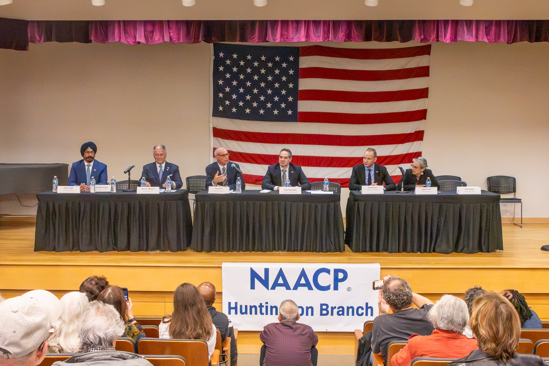 Candidates for Suffolk County and New York State seated at a long table on the stage. Photo Stories: 2026 NAACP Huntington Branch Meet the Candidates Night