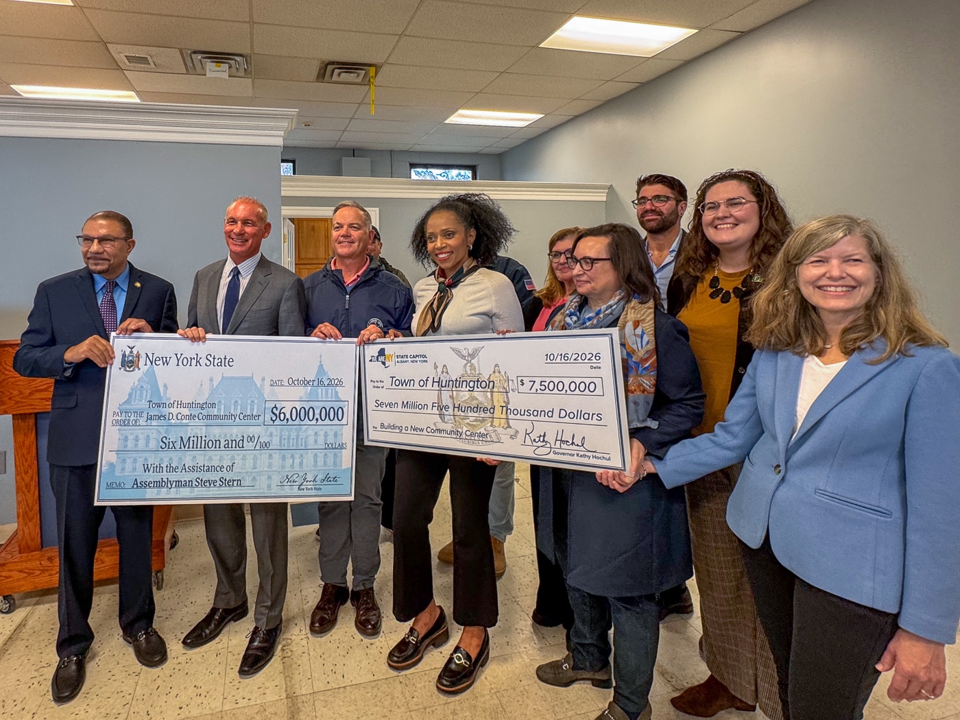 Deputy Assembly Speaker Phil Ramos, Assemblyman Steve Stern, Huntington Supervisor Ed Smyth, Receiver of Taxes Jillian Guthman, Deborah Conte, Karen Persichilli Keogh - Secretary to Governor Kathy Hochul, 2nd Row Jeffrey Conte, Samantha Conte and Councilwoman Jennifer Hebert (right) hold ceremonial checks from New York State for $13.5 million. Finally! $19.5 Million Clears the Way for the Conte Community Center